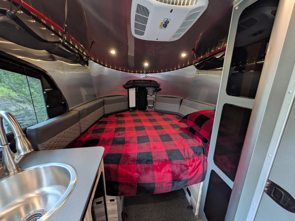 Rear bed area with ambient lighting and overhead storage nets